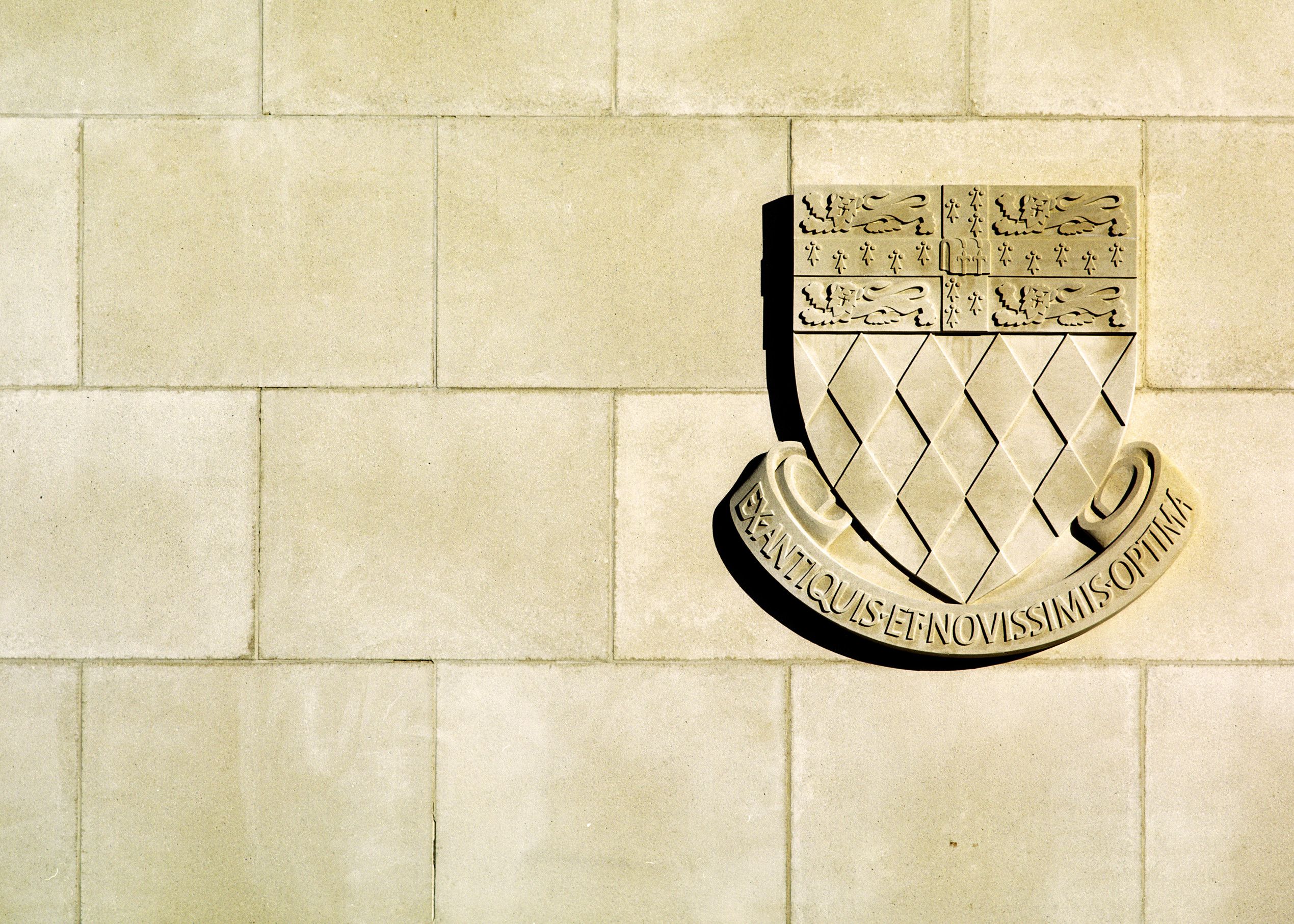 cream stone crest on gatehouse wall